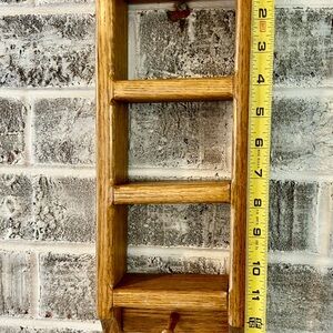 This is a vintage-style, small, oak wood ladder shelf.